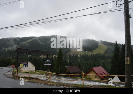 Fog above the slope in a ski resort Stock Photo