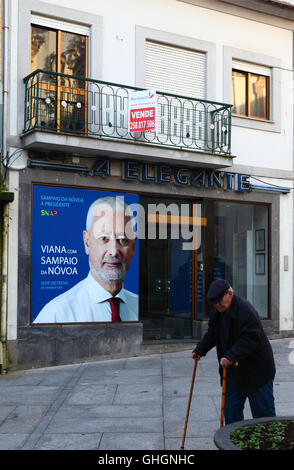 Elderly man walking past poster for 2016 presidential election candidate António Sampaio da Nóvoa, Viana do Castelo, Portugal Stock Photo