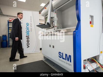 Duesseldorf, Germany. 14th Sep, 2016. A man looking at the laser melting facility during the opening of a new research centre for 3D metal printing of the company in Duesseldorf, Germany, 14 September 2016. The group bundles its research in the area of 3D printing with the title 'voestalpine Additive Manufacturing Center GmbH'. PHOTO: WOLFRAM KASTL/dpa/Alamy Live News Stock Photo