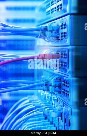 Fiber network switch with some yellow optical network cables Stock Photo