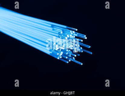 optical fibres dinamic flying from deep on technology background Stock Photo