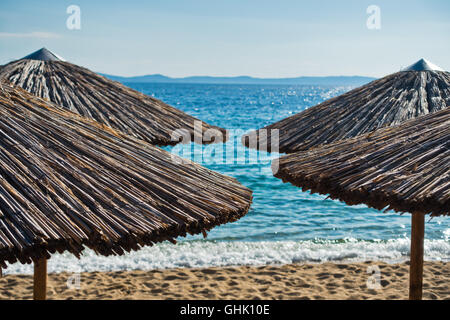 Straw parasols on a beach in Sithonia Stock Photo