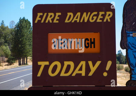 Very high risk of fire warning sign on side of road with figure of Yogi bear. Near Yosemite National Park.  California. USA Stock Photo