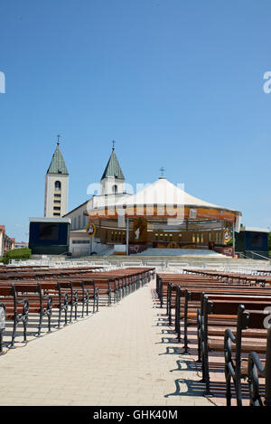 MEDUGORJE, BOSNIA AND HERZEGOVINA - JULY 4, 2016: Benches and altar behind the parish church of St. James, the shrine of Our Lad Stock Photo