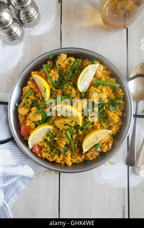Spanish paella with rabbit, tomatoes and green beans Stock Photo