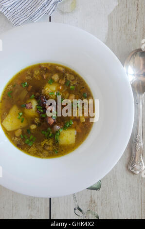 Lentil and bacon soup topped with chopped chives Stock Photo