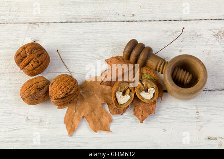 Autumn still life of fall leaves and walnuts on a grunge wooden background Stock Photo