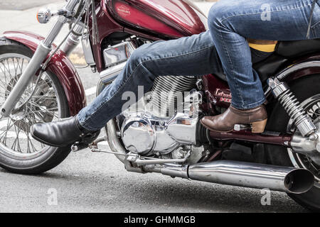 Female pillion passenger on powerful motorbike Stock Photo