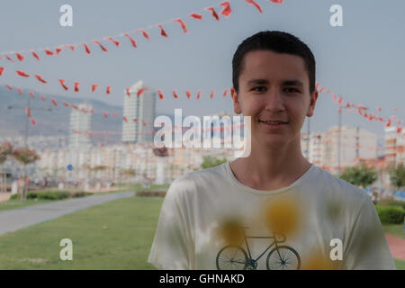 Portrait of a young  handsome boy smilling in front of city Stock Photo