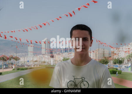 Portrait of a young  handsome boy smilling in front of city Stock Photo