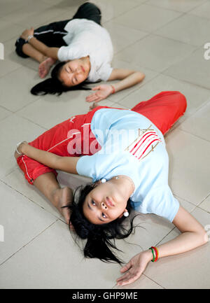 Students from Cambodia Living Arts stretch before a class. Phnom Penh, Cambodia Stock Photo