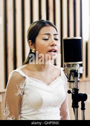 Ouch Savy records at the  Cambodian Living Arts recording studio in Phnom Penh, Cambodia. Stock Photo