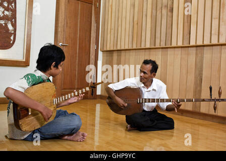 Chapei Master Suon Peng teaches a young student at the Cambodia Living Arts recording studio in Phnom Penh, Cambodia. Stock Photo