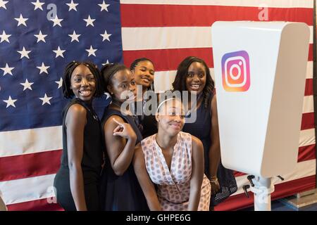 Attendees at the Democratic National Convention poses in the Instagram flag Photo Booth sponsored by Facebook at the Wells Fargo Center July 27, 2016 in Philadelphia, Pennsylvania. Stock Photo