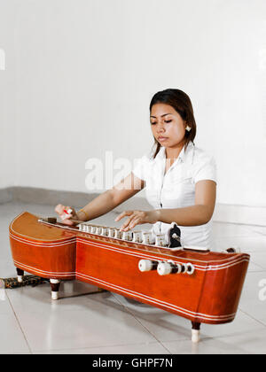 Ouch Savy practices her Takhe. Phnom Penh,Cambodia Stock Photo