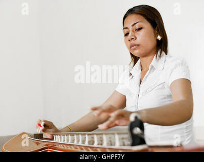 Ouch Savy practices her Takhe. Phnom Penh,Cambodia Stock Photo