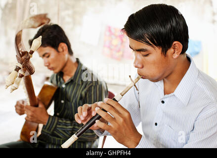 Sralai (right) and Chapei (left ) students practice traitional Khmer Wedding music. Kampong Speu province, Cambodia. Stock Photo