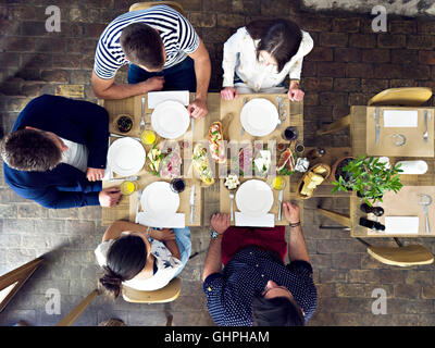 Group of friends having lunch in restaurant Stock Photo