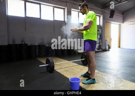 Athlete in gym prepares for weightlifting Stock Photo