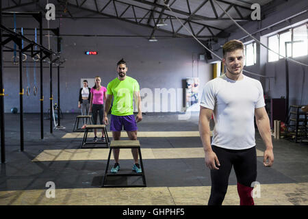 Athletes prepare for doing box jumps in gym Stock Photo