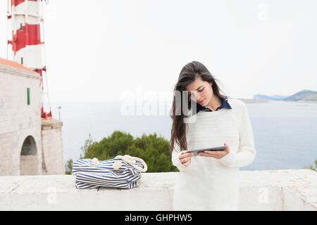 Young woman using digital tablet at the seaside Stock Photo