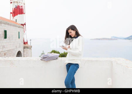 Young woman using digital tablet at the seaside Stock Photo