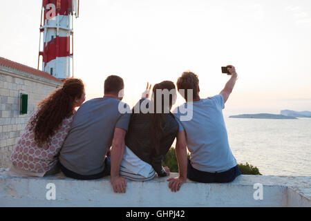 Group of friends taking selfie at the seaside Stock Photo
