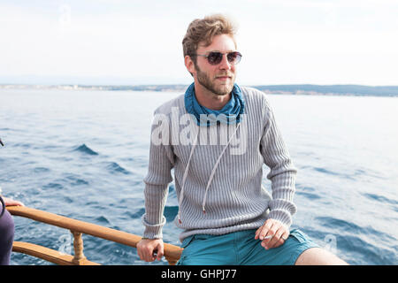 Portrait of young man with sunglasses on yacht Stock Photo