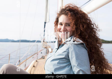 Portrait of happy young woman on yacht Stock Photo