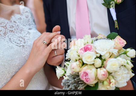 bride and groom holding hands with bridal bouquet
