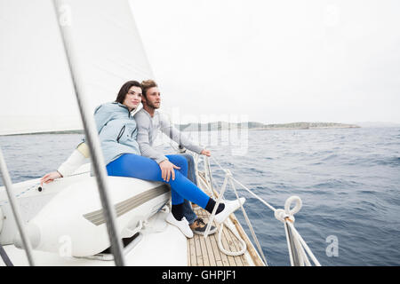 Young couple on yacht looking out to sea Stock Photo