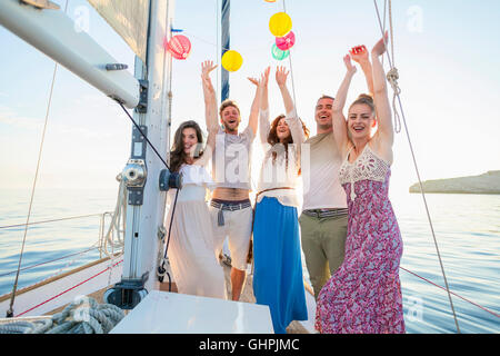 Group of friends on sailboat having fun Stock Photo