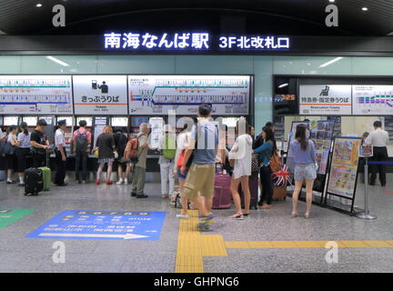 People queue to buy tickets at Nankai Nanba Station in Osaka Japan. Stock Photo
