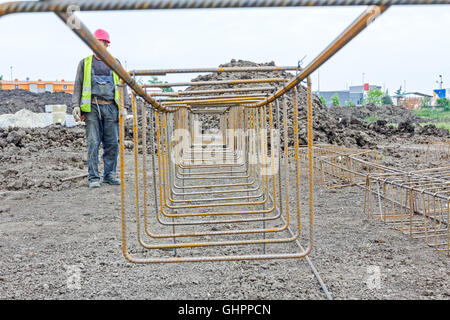 View perspective trough cage, skeleton of reinforcing steel bar at construction site. Stock Photo