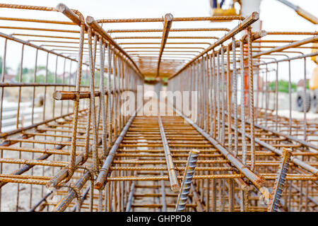 View perspective trough cage, skeleton of reinforcing steel bar at construction site. Stock Photo