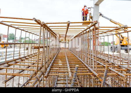 View perspective trough cage, skeleton of reinforcing steel bar at construction site. Stock Photo