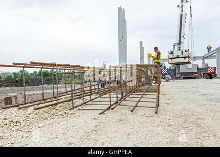 View perspective trough cage, skeleton of reinforcing steel bar at construction site. Stock Photo