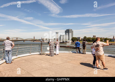 Tourists at the Rhine River promenade with a nice view in the city of Cologne, Germany Stock Photo