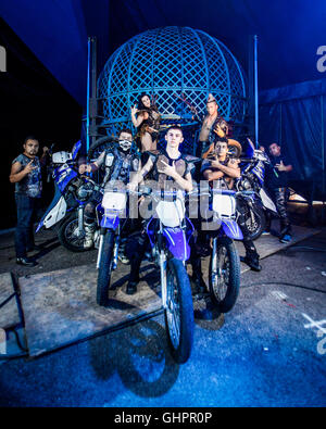 Circus of Horrors cast:  Group portrait of the daredevil motorcycle stunt riders in front of their 'Globe of Death'. Stock Photo