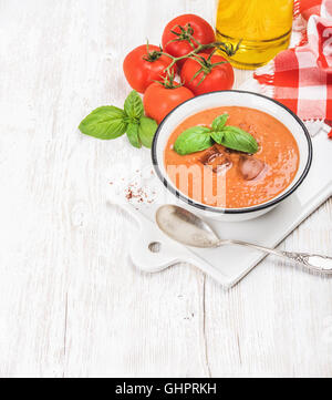 Cold gazpacho soup with ice, fresh basil and red tomatoes Stock Photo