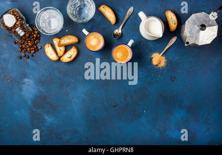 Coffee espresso, cantucci, cookies and milk over dark blue background Stock Photo