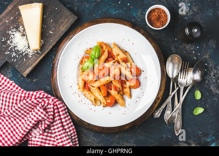 Pasta penne with tomato sauce, basil and roasted tomatoes Stock Photo