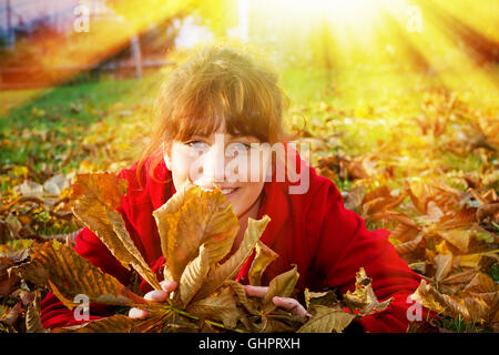 Happy girl lying in autumn Stock Photo