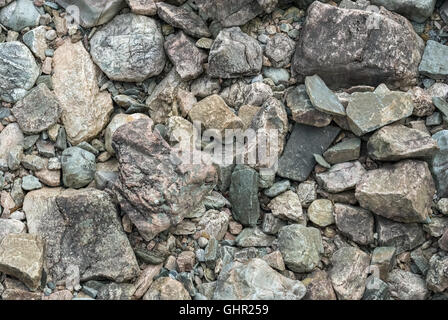 The background of grey rocks and boulders, located on the bottom of the dry riverbed. Stock Photo
