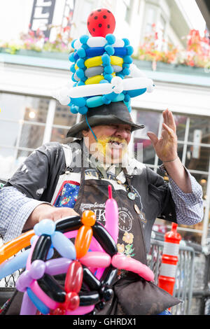Seattle, Washington: Twister Thomas models balloons at Pike Place Market. Stock Photo