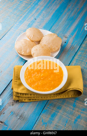 Aamras or Aam Ras Puri: Puri which is an indian fried small bread and alphonso mango pulp is a popular lunch in summer Stock Photo