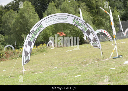 SUNDAY 31st July 2016.  AN FPV racing drone crosses  the start/finish line during a race at the UK drone racing competition, The Stock Photo
