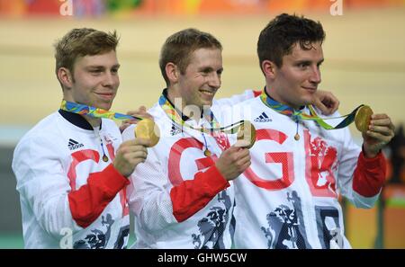 Rio De Janeiro, Brazil. 11th Aug, 2016. Philip Hindes(L), Jason Kenny(C) and Callum Skinner of Great Britain show the gold medal at the awarding ceremony of the men's team sprint final of cycling track at the 2016 Rio Olympic Games in Rio de Janeiro, Brazil, on Aug. 11, 2016. Great Britain won the gold medal with a result of 42:440. Credit:  Li Ga/Xinhua/Alamy Live News Stock Photo