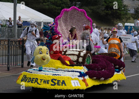 Jersey, Channel Islands, UK. 11th August, 2016. A participant float and contingent along the parade route of the Jersey Battle of Flowers 2016 Credit:  imagegallery2/Alamy Live News Stock Photo