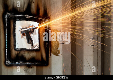 Industry worker with welding steel to repair container structures manufacture workshop in factory industry. Stock Photo